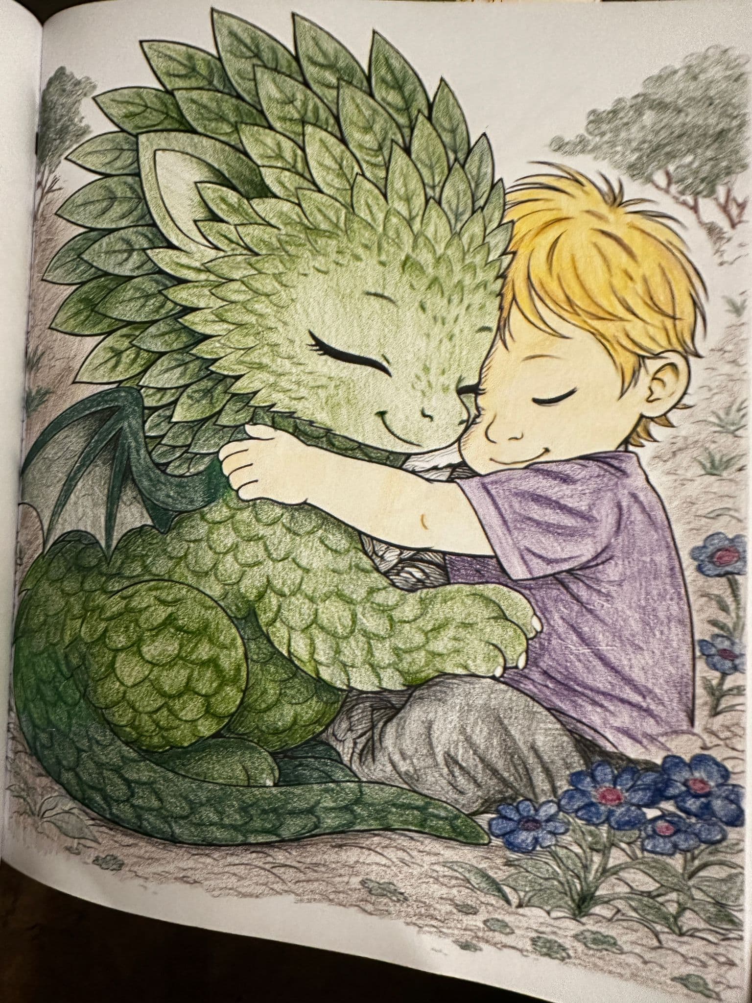 Child hugging a dragon plush