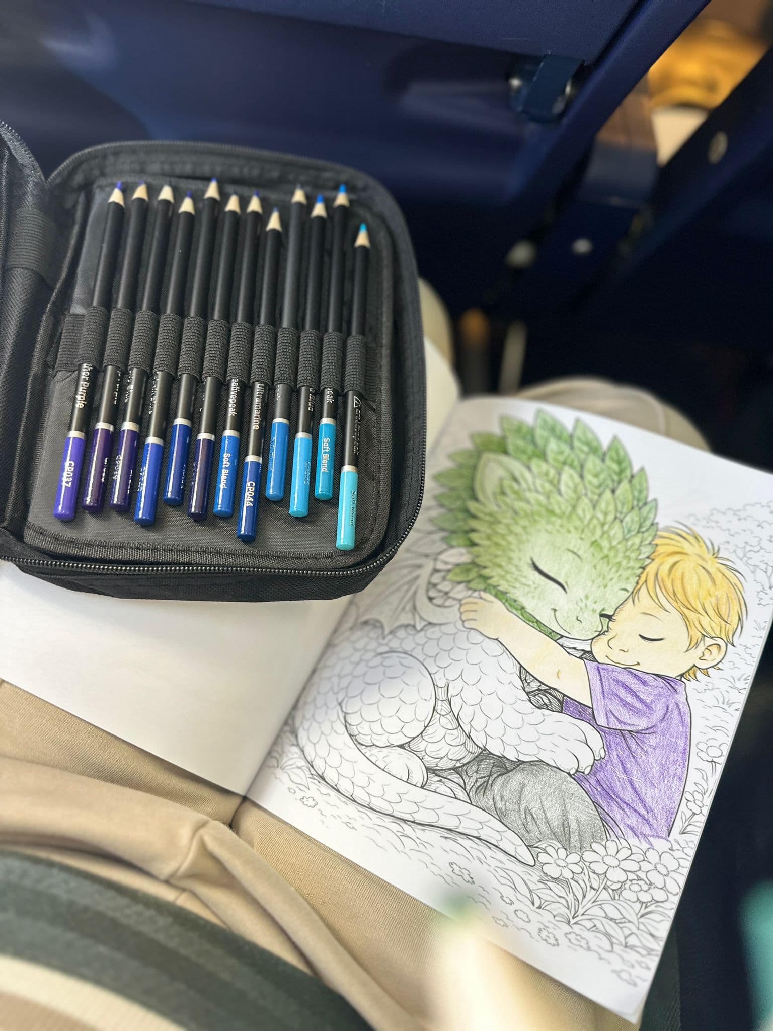 Opened dragon book with pencils beside it