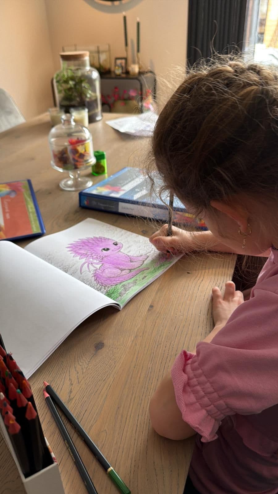 Child drawing in the dragon colouring book