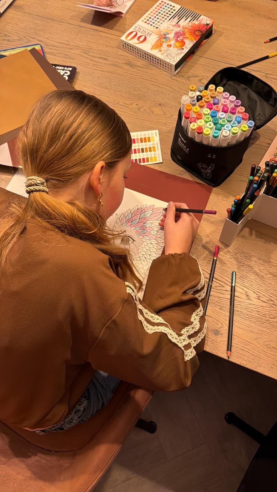 Child colouring a dragon page