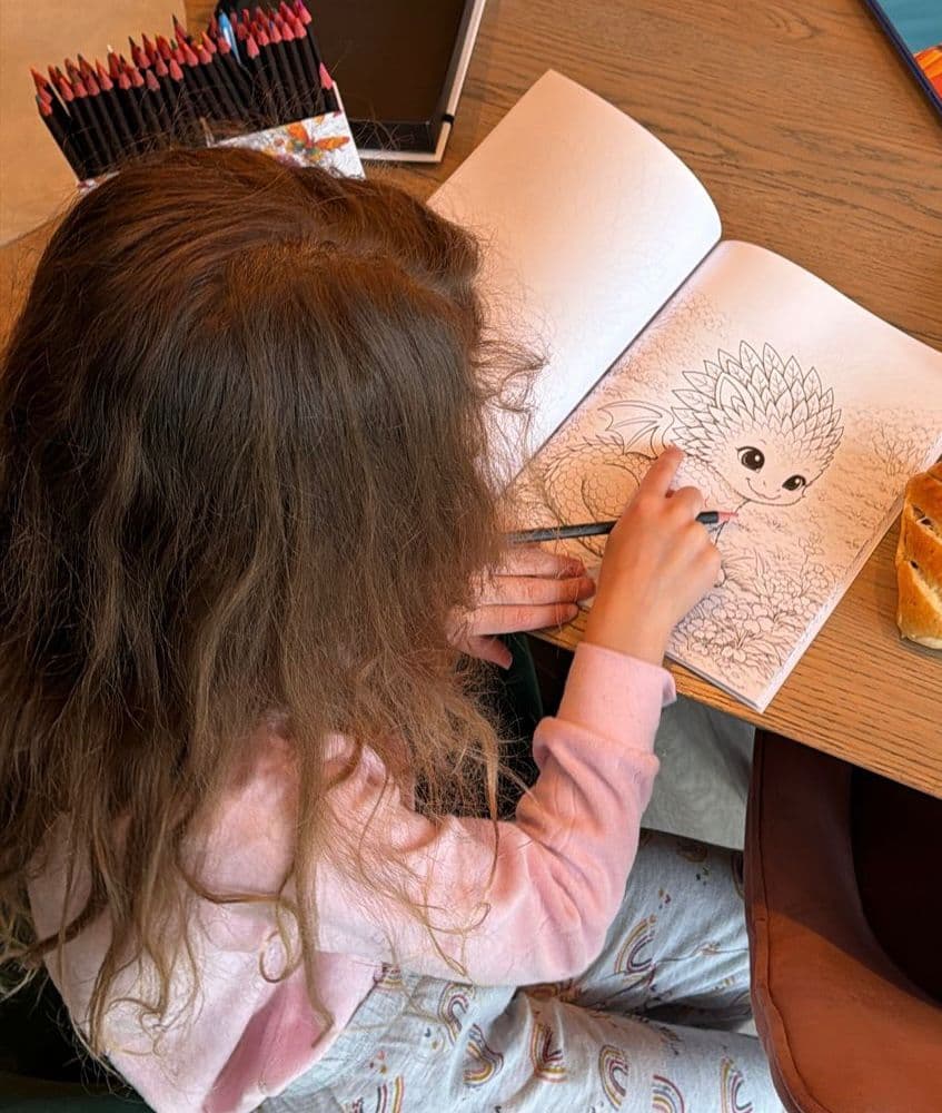 Child enjoying the dragon colouring book